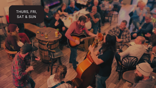 A four piece strings band playing in the centre of the crowd at Brewer's Pantry.